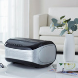 Black | Black Homedics TotalClean Desktop Air Purifier on table next to plant