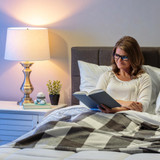 Gray | Woman relaxes in bed with a gray Homedics Marbelous Mini Massager on nightstand