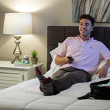 Gray | Man relaxes on bed with a gray Homedics Marbelous Mini Massager on nightstand