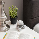 Gray | Gray Homedics Marbelous Mini Massager sitting on a table with lamp, plants, and books