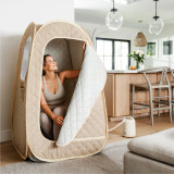image shows SaunaZen Portable Steam Sauna used by woman inside home
