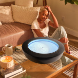 Walnut | a woman looks into the drift 21" with the drift 21" wood ring and practices mindfulness