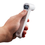 White | Hand holds the white Homedics Infrared Ear and Forehead Thermometer in white