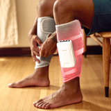 close up view of the Homedics Real Relief Calf Compression Massager on man's legs